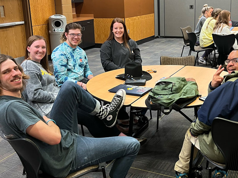 A group of students sitting around a table.